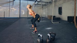 Young fitness female doing CrossFit ®* workout